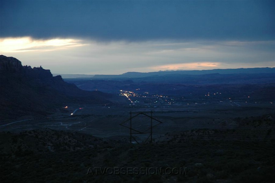 128. Way high over the highway, we see the town of Moab..jpg